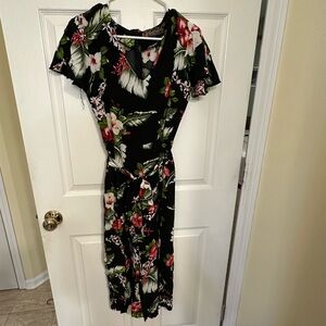 Black jumpsuit with tropical floral print and matching fabric belt